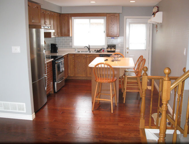 Installed new engineered hardwood flooring & re-installed kitchen cabinets.