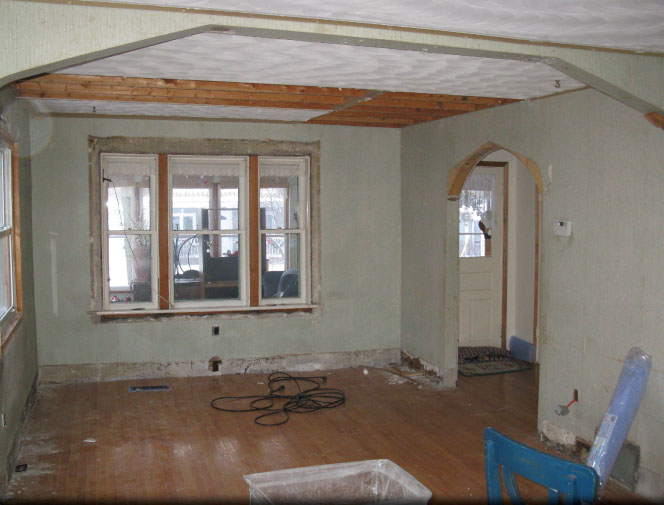 Livingroom/diningroom reno. Stripped down to bare walls. Beams added & old archways removed.